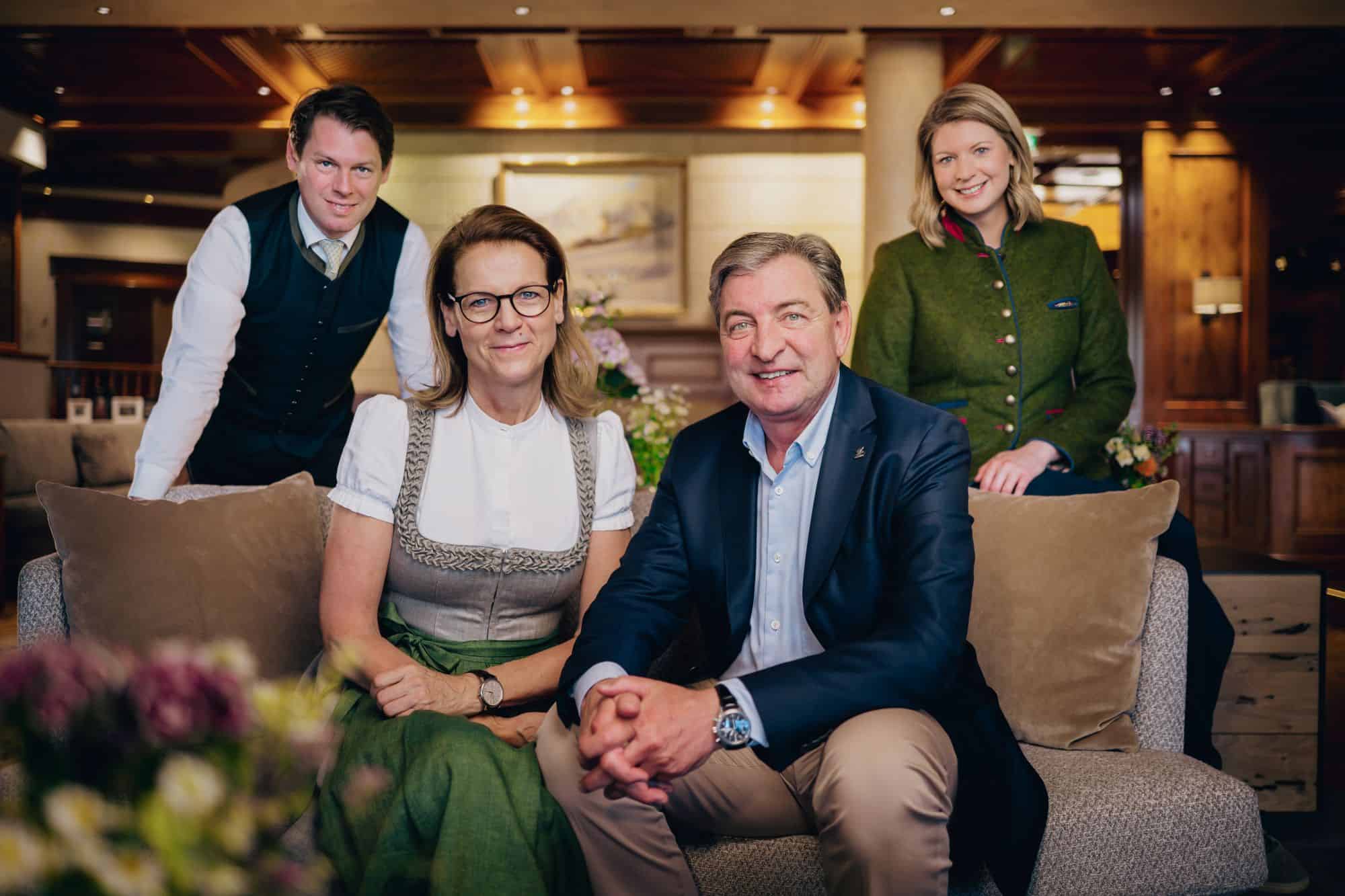 Five people in traditional dress are sitting on a sofa